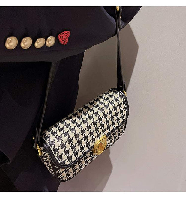 Houndstooth Baguette Bag with classic pattern and shoulder strap.