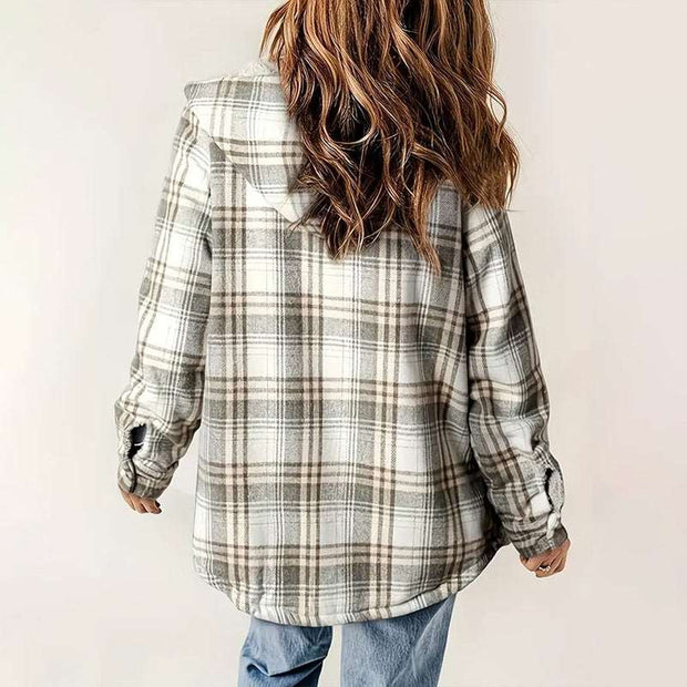 Back view of woman wearing beige and white plaid hooded fleece-lined jacket with casual jeans