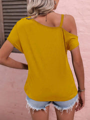 Women's yellow off-shoulder blouse with casual chic style, paired with denim shorts.