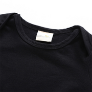 Batman Baby Onesie with soft black cotton fabric and branded tag.