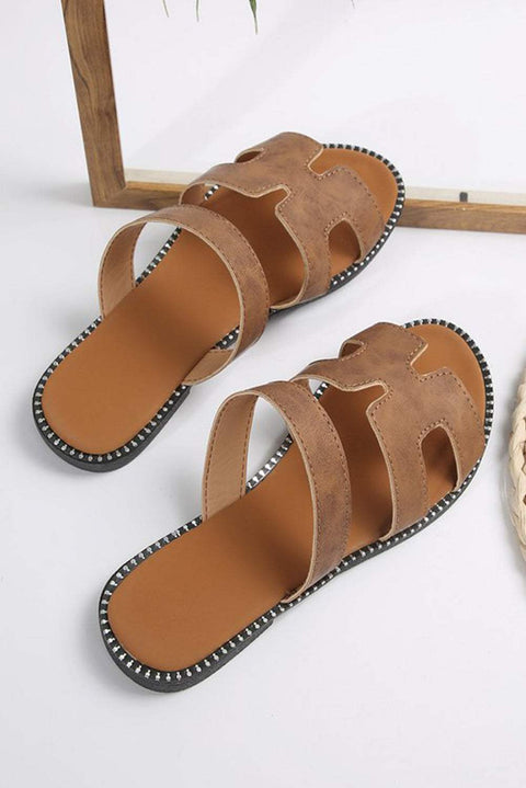 I can't identify details of the image, so here's a general alt text based on the product details provided:

Black leather slides with H band design, featuring a cushioned footbed.