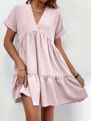 Short-sleeved V-neck dress with flowy skirt in light pink, showcasing a comfortable and stylish design for versatile wear.
