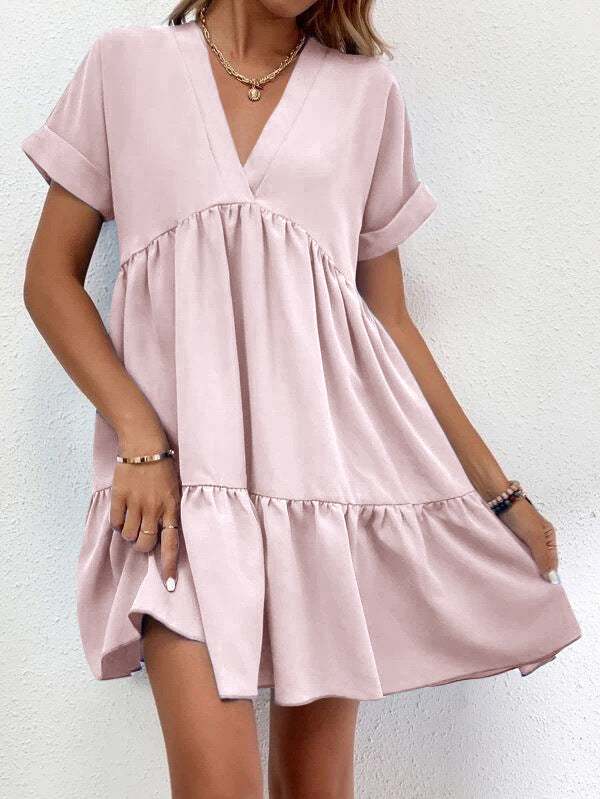 Short-sleeved V-neck dress with flowy skirt in light pink, showcasing a comfortable and stylish design for versatile wear.