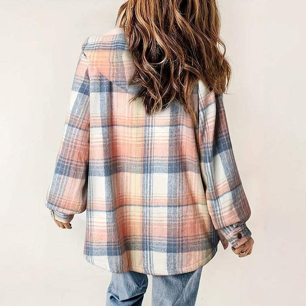Woman wearing a plaid hooded fleece-lined jacket in pastel shades of pink, blue, and white, styled with blue jeans, back view.