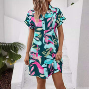 Floral print short sleeve shirt dress in vibrant colors with button-down front and relaxed fit.