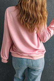 Pink crew neck sweatshirt with a relaxed fit paired with jeans, showcasing its casual style and soft fabric.