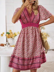 Floral Smocked Waist Mini Dress with pink and red floral print, short sleeves, and smocked waist design.
