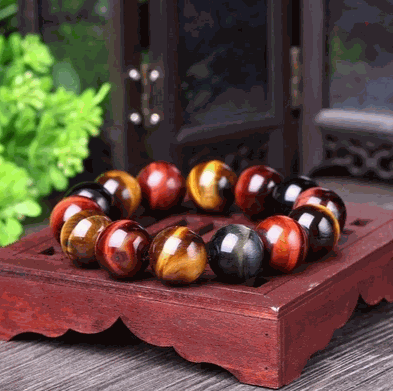 Tiger Eye Bracelet featuring natural stones with golden and brown hues on a wooden box.
