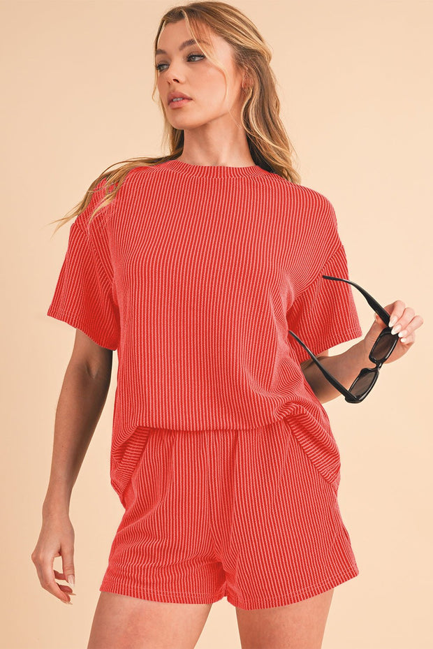 Orange ribbed tee and shorts set featuring a loose-fit design with a round neckline and short sleeves.