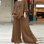 Solid color linen pants and shirt set with long sleeves and pockets, made of breathable cotton linen material.