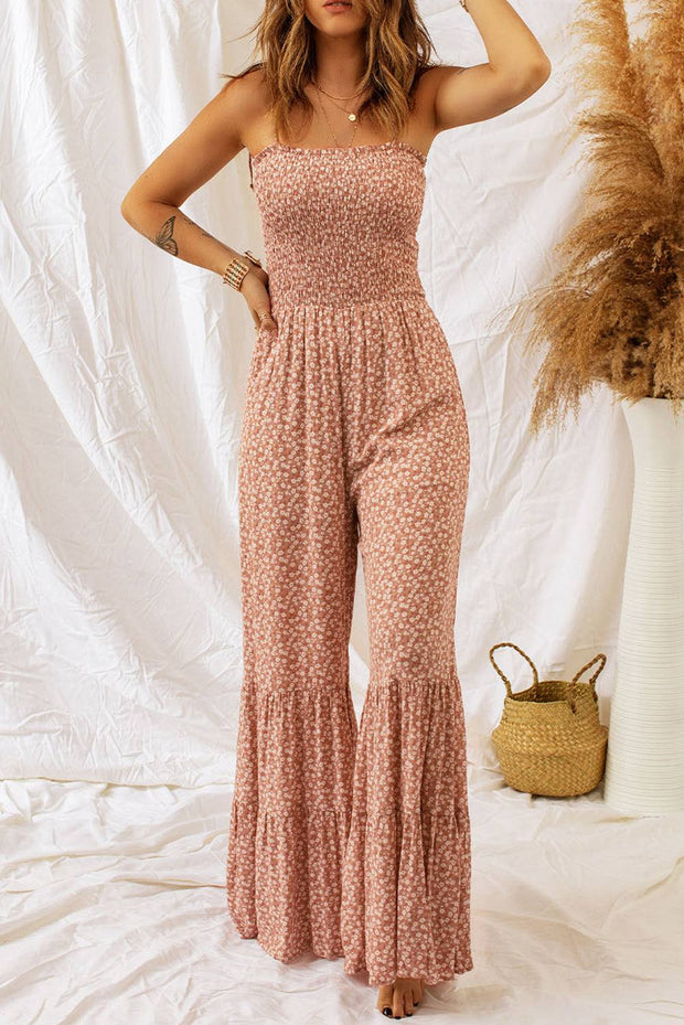 Dusk Blue Floral Jumpsuit with spaghetti straps and smocked bodice displayed on a model against a white backdrop.