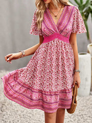 Floral Smocked Waist Mini Dress with short sleeves and pink floral print.