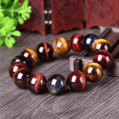 Tiger Eye Bracelet with natural crystal beads featuring golden and brown hues on a rustic wood surface.