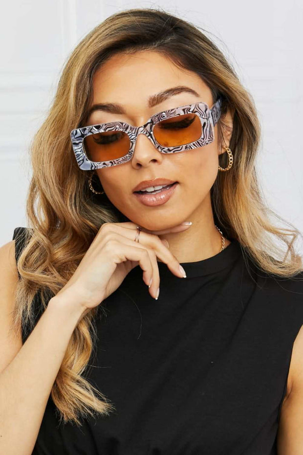 Tortoiseshell rectangle polycarbonate sunglasses on woman, fashionable design, UV protection.