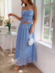 Frill Square Neck Cami and Skirt Set in blue with delicate frills and A-line silhouette, styled with white sandals and purse in a bright room.