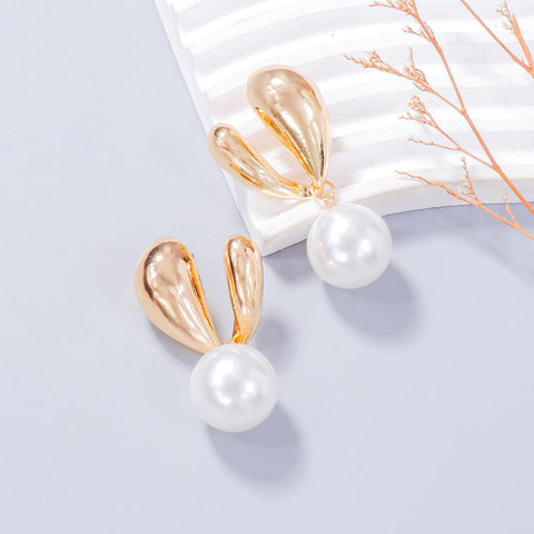 Alloy Drip Oil Bunny Earrings with pearl detail on a white background.