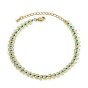 Gold charm bracelet with blue accents and secure clasp.