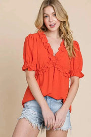 Lime N Chili Ruffled Puff Sleeve Babydoll Top in vibrant orange, featuring a deep V-neckline and ruffled details.