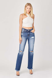 Woman wearing RISEN Distressed Straight Jeans with trendy rips and raw hem.