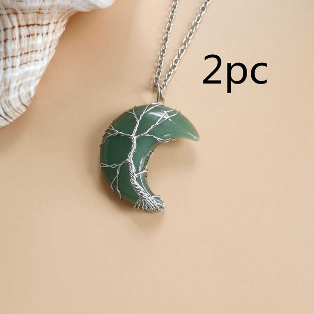 Moon Tree Of Life Necklace with crystal pendant featuring celestial accents on a water wave chain.