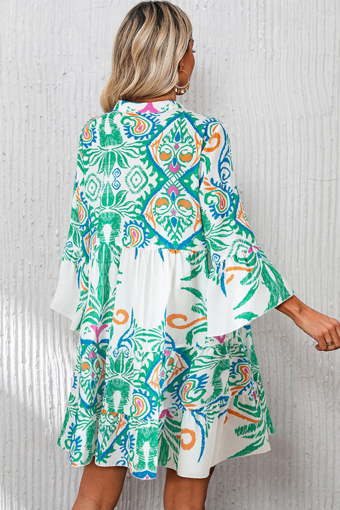 White Boho Print Mini Dress with vibrant ethnic design and ruffled hems, perfect for summer vibes.