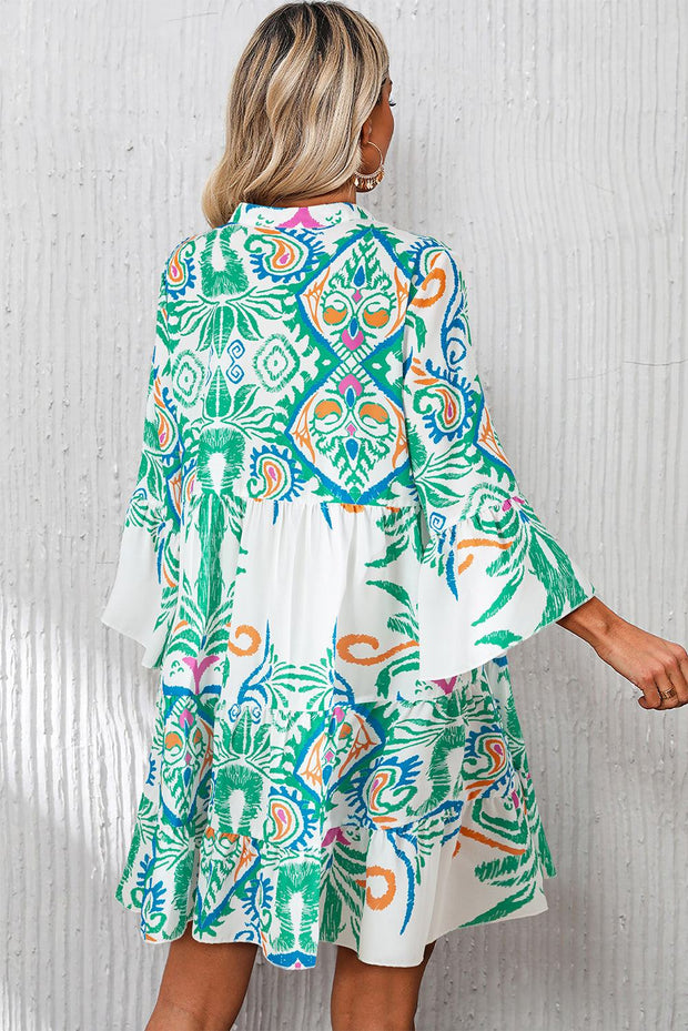 White Boho Print Mini Dress with vibrant ethnic design and ruffled hems, perfect for summer vibes.