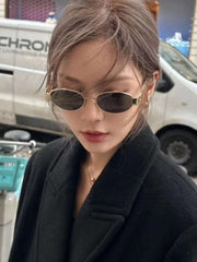 Metal Oval Vintage Sunglasses with a durable metal frame worn by a woman in a stylish setting.