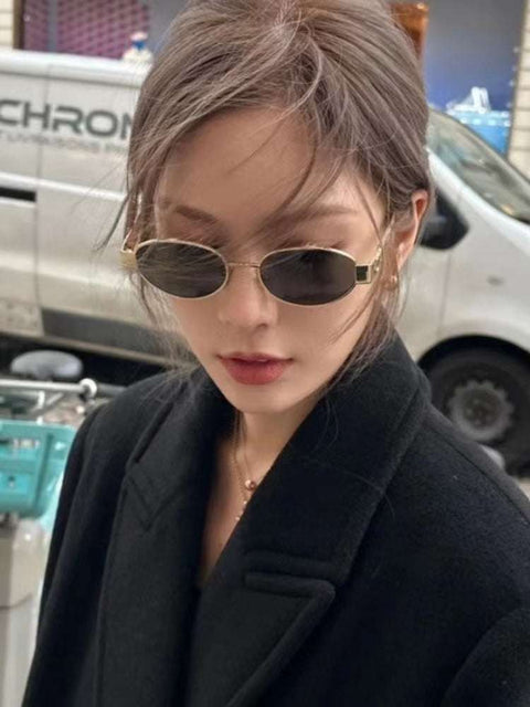 Metal Oval Vintage Sunglasses with a durable metal frame worn by a woman in a stylish setting.