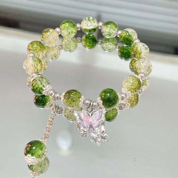 Whimsical Fairy Beads Butterfly Bracelet with green glass beads and butterfly charm.