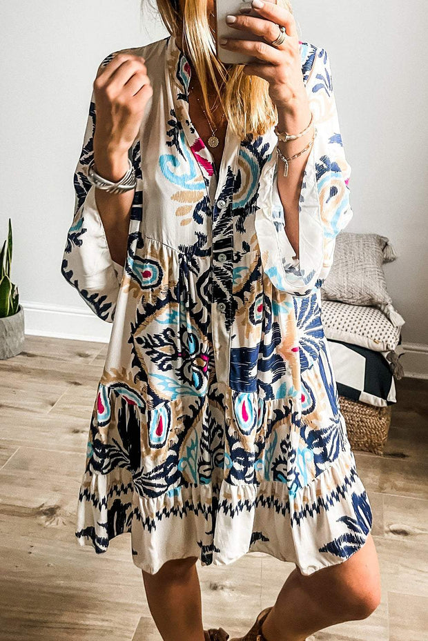 White Boho Print Mini Dress with artistic patterns, relaxed fit, and playful silhouette.