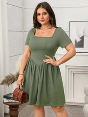 Plus size square-neck short-sleeve mini dress in soft green, featuring a flattering fit and comfortable design.