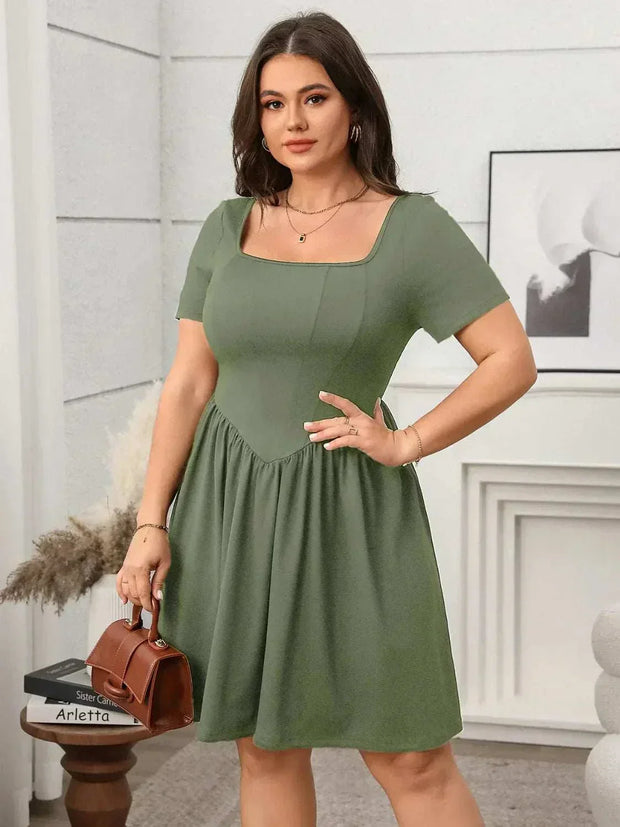 Plus size square-neck short-sleeve mini dress in soft green, featuring a flattering fit and comfortable design.