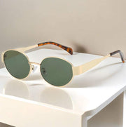 Metal Oval Vintage Sunglasses with gold frame and green lenses on display.