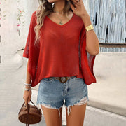 V-Neck Bat Sleeve T-shirt in red, styled with denim shorts, showcasing chic casual fashion.