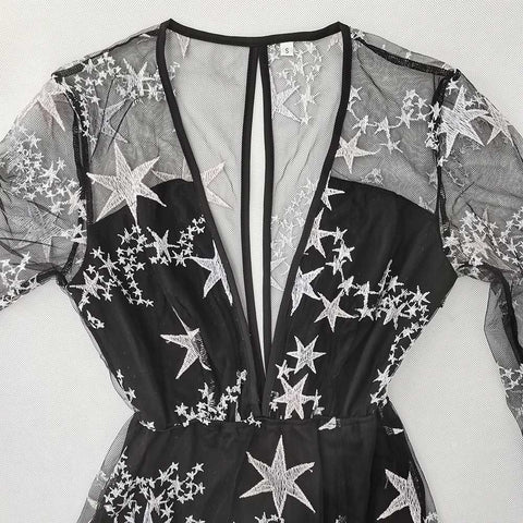 Elegant black lace dress with star patterns, V-neck, and high waist design.