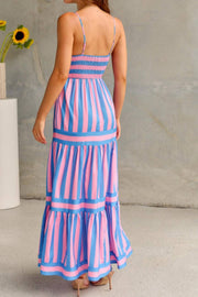 Pink and blue striped smocked dress with spaghetti straps, featuring a tiered design.