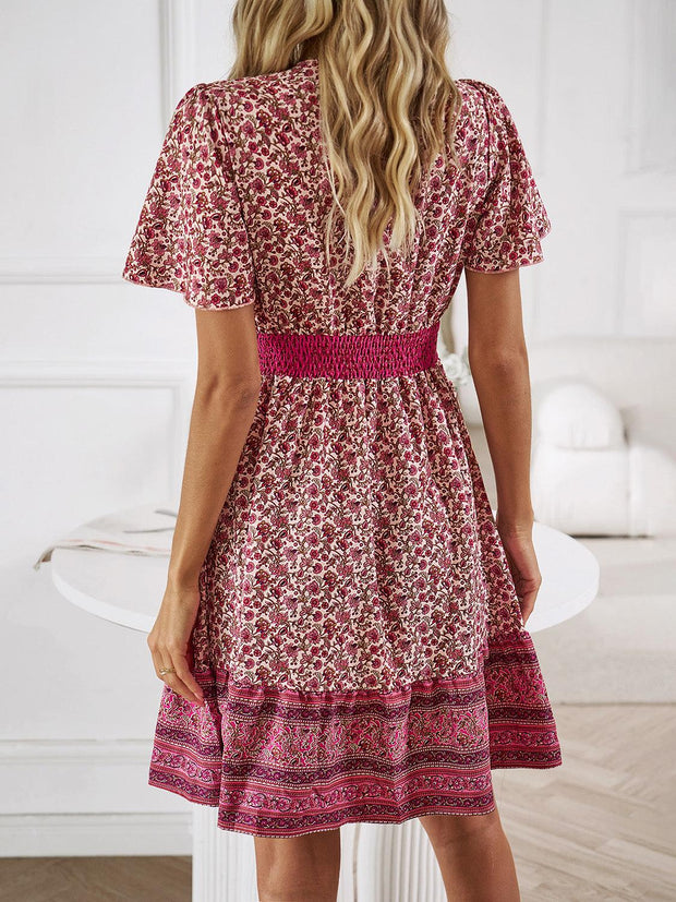 Floral Smocked Waist Mini Dress with short sleeves and vibrant floral print.