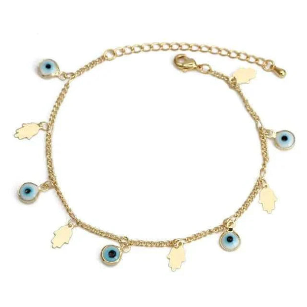 Gold charm bracelet with blue eye charms and leaf ornaments.