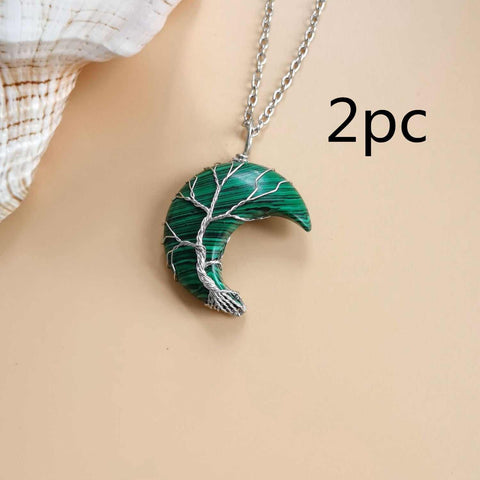 Moon Tree of Life necklace with silver chain and green crescent pendant featuring tree design.
