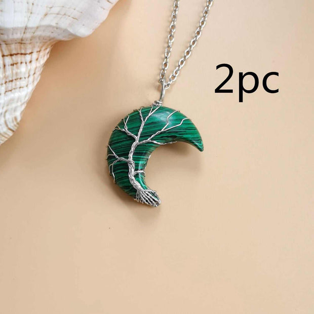 Moon Tree of Life necklace with silver chain and green crescent pendant featuring tree design.