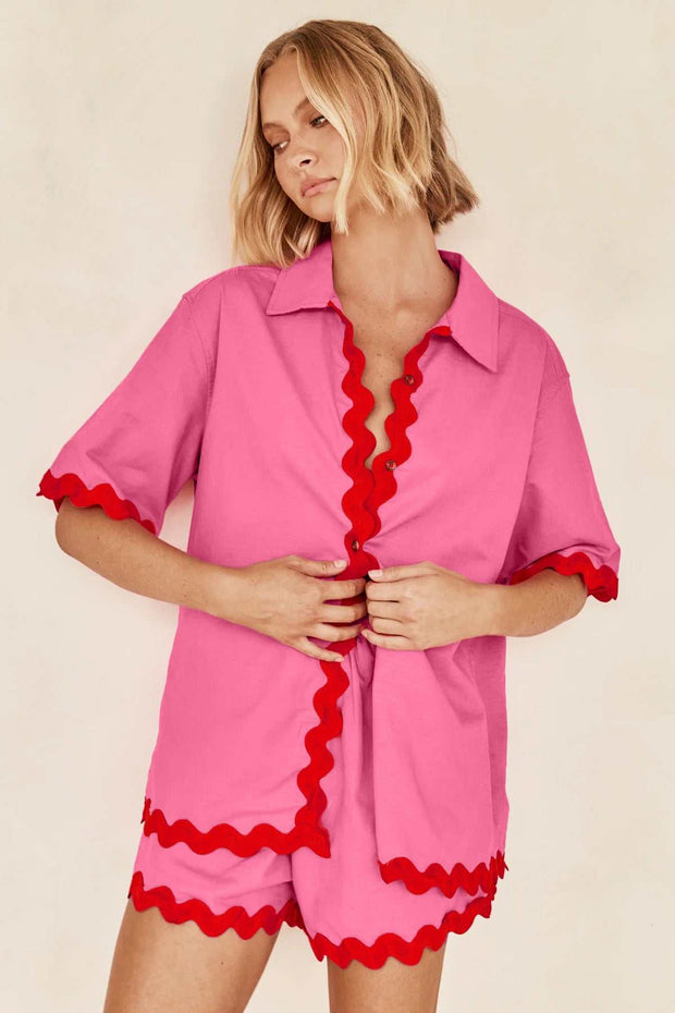 Pink 2 piece summer suit with red accents on woman, stylish and breathable.