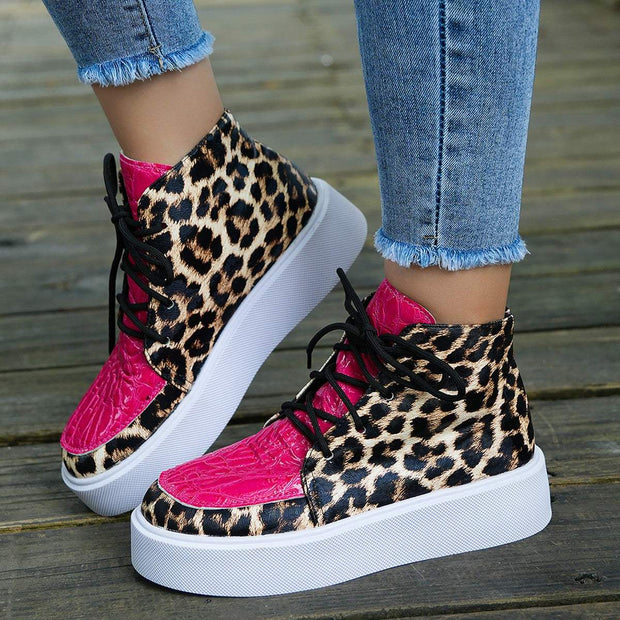 Leather Leopard Platform Sneakers with chic leopard print and pink accents on a wooden deck.