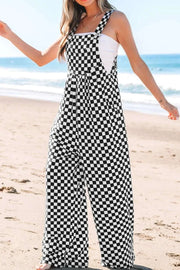 Checkered print pocketed wide leg jumpsuit on the beach.