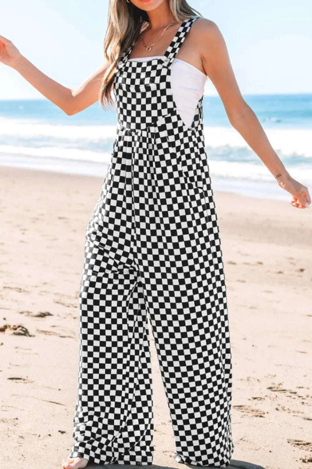 Checkered print pocketed wide leg jumpsuit on the beach.