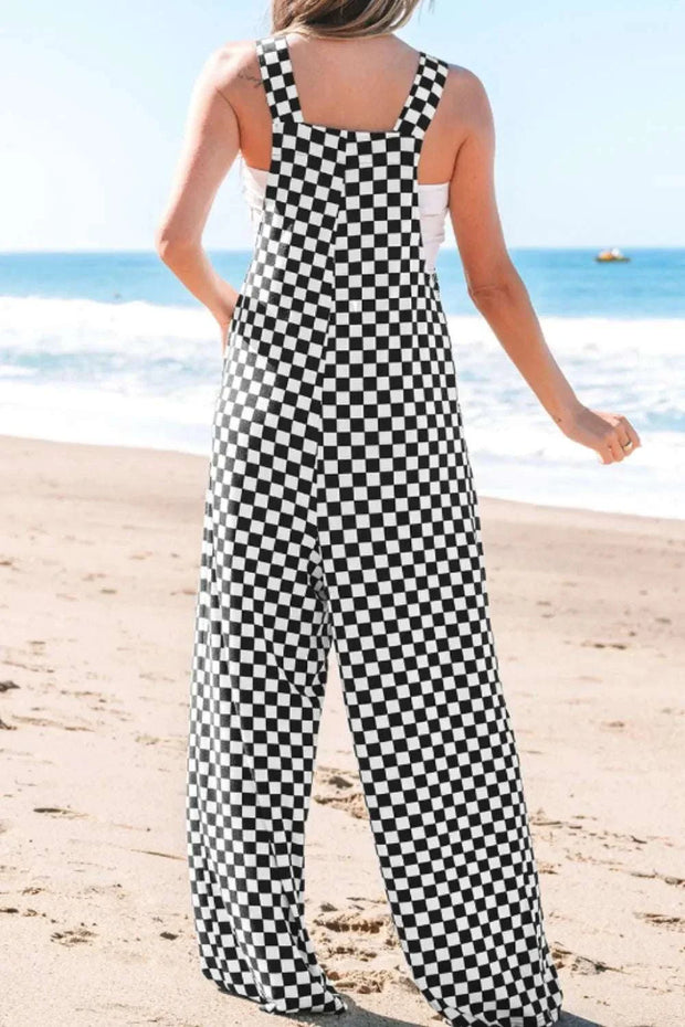 Checkered print pocketed wide leg jumpsuit on beach.