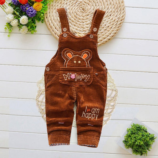 Children overalls with cartoon pattern and adjustable straps on a white background.
