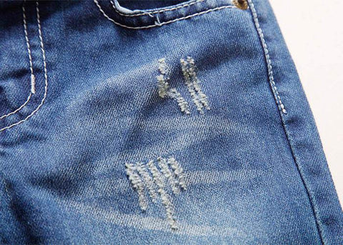 European style boys' ripped jeans with distressed detailing.