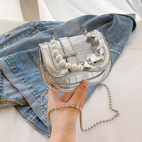Laser Pearl Girl Tote with silver laser-cut design and pearl accents on denim background.