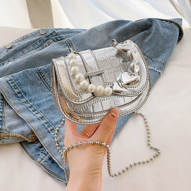 Laser Pearl Girl Tote with silver laser-cut design and pearl accents on denim background.