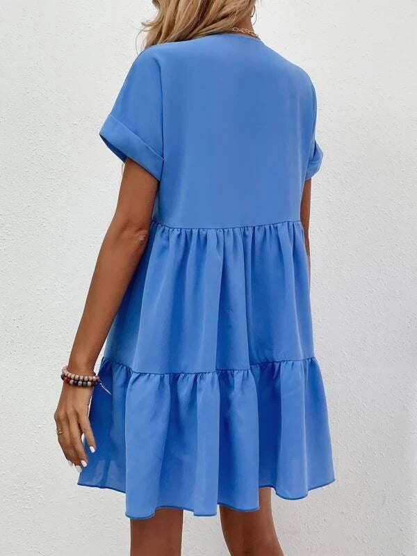 Short-sleeved V-neck dress in blue with a flowy skirt design, showcasing style and comfort.